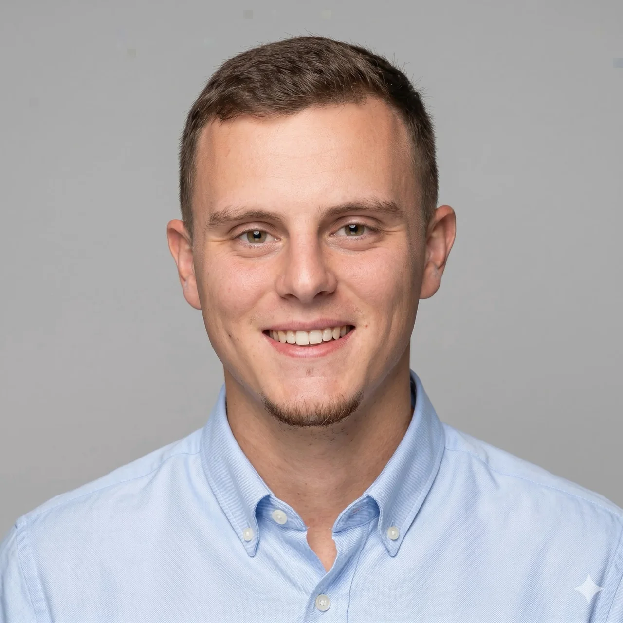 Amit Chemi, smiling in a light blue shirt
